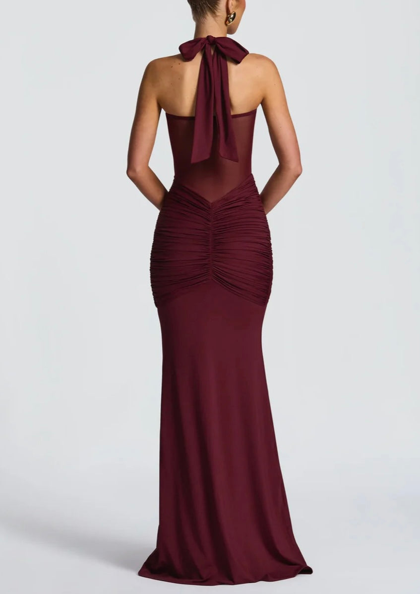 Burgundy evening gown with a halter neck design on a white background