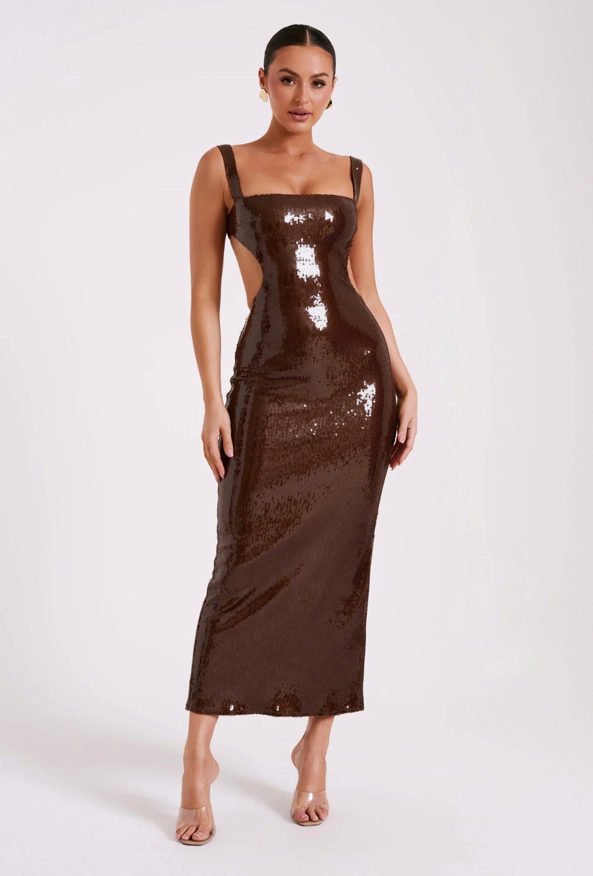 Woman wearing a brown sequin dress on a white background