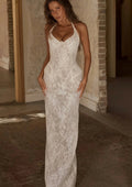 Woman wearing a white lace dress in an indoor setting